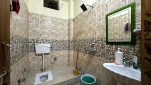 a bathroom with a sink and a toilet at Varanasi Bliss Stay in Varanasi +22 photos