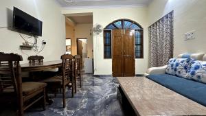 a living room with a couch and a table at Varanasi Bliss Stay in Varanasi