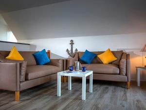 a living room with a couch and a table at Heron in Wroxham