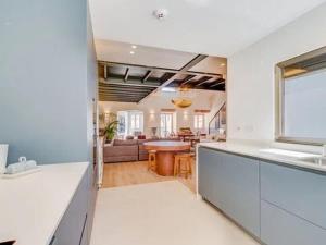 a kitchen and living room with a couch and a table at Super apartamentos para qualquer um de Silva in Paço de Arcos
