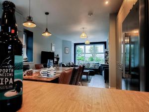 a bottle of wine sitting on a table in a living room at Llywnfor in Morfa Nefyn