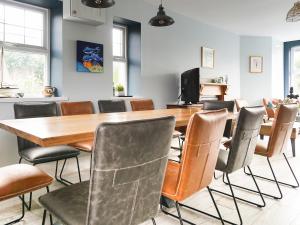a conference room with a wooden table and chairs at Llywnfor in Morfa Nefyn