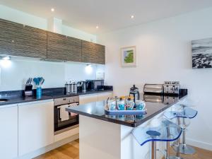 a kitchen with white cabinets and a counter top at 7 Cribbar in Newquay