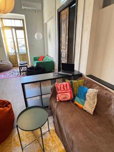 a living room with a couch and a table at Bee Hostel in Limassol