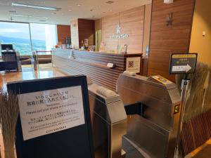 a fast food restaurant with a cash register and a counter at JR Kyushu Hotel Blossom Oita in Oita