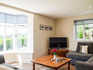 een woonkamer met een bank en een tafel bij Barnleigh in Ludlow