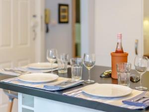 a table with plates and wine glasses on it at Viking Bay Apartment in Broadstairs +13 photos