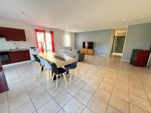 a kitchen and dining room with a table and chairs at Maison plain-pied in Saint-Clair +19 photos