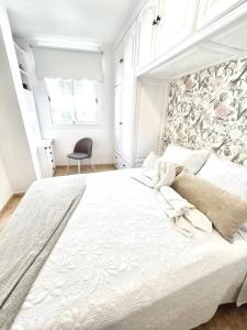 a bedroom with a large white bed with a stone wall at Piso céntrico Corazón de Aridane in Los Llanos de Aridane