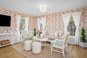 a living room with a couch and chairs and a tv at Downtown 10 min, 90 degree F Pool & Spa, Linked 2 homes, Gated Parking in Houston +39 photos