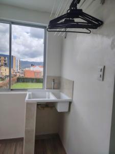 ein weißes Waschbecken in einem Raum mit einem Fenster in der Unterkunft Casa Blanca in Cajicá + 67 Fotos