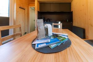 a pile of books sitting on top of a table at Tinyhouse Wald-Liesl in Neuwerk