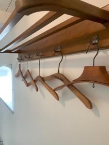 a group of wooden hangers hanging from a ceiling at Stone house with direct access to Haraldsted Lake in Ringsted