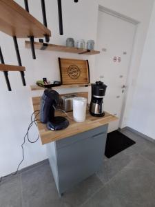 a kitchen with a counter with a coffee maker on it at Gîte du Papillon CALUTRE in Carvin