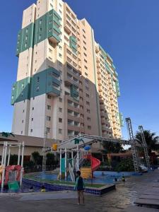 a large building with a playground in front of it at Enjoy olimpia park resort in Olímpia