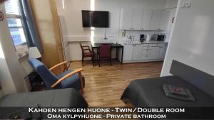 a living room with a kitchen with a table and chairs at Hotel 24 - Karihaara - Kemi in Kemi