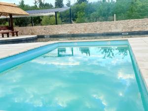 a large swimming pool with blue water at Valle Serrano in Mina Clavero +57 photos