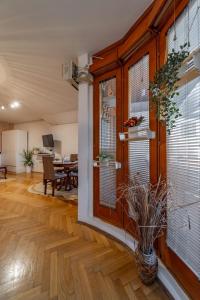 a living room with a large window with a vase at Ada Home Belgrade Apartment 