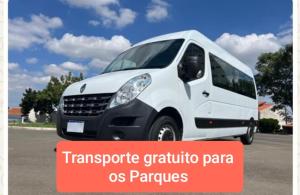 a white van is parked in a parking lot at Chalés Chácara Santa Felicidade 2 in Olímpia