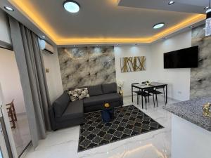 a living room with a couch and a table at Luxury NEW Stylish apartment Bayahibe with pool in Bayahibe