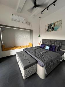 a bedroom with a large bed in a room at Casa Oceanus - Sea Facing Forest View Room - Ganpatipule in Nevra