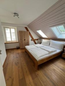 a bedroom with a large bed in a attic at Gasthaus zum Freihof in Engi
