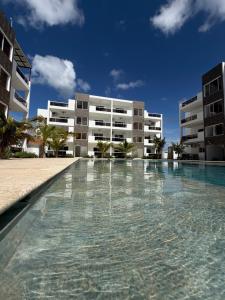 a swimming pool in front of a building at Luxury NEW Stylish apartment Bayahibe with pool in Bayahibe