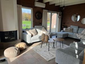 a living room with a couch and a fireplace at het Veenhuus in Nieuwlande