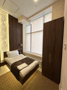 a bedroom with a bed and a large window at The Palm hotel & spa in Almaty +27 photos