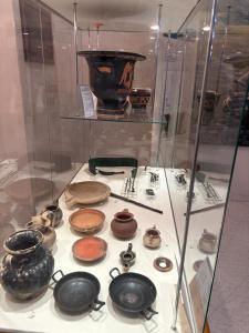 a display case filled with different types of pottery at INcentro in Bitonto