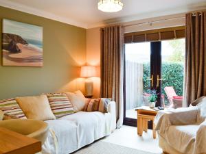 a living room with a couch and a window at Ty Glyndwr in Ystalyfera