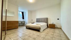 a large bedroom with a bed and a bathroom at Fronte Mare Ampio Quadrilocale in Alassio