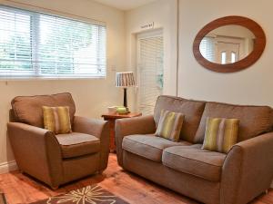 a living room with a couch and a chair at The Orangery in Bideford