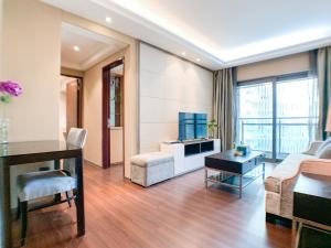 a living room with a couch and a table at Hesheng Hotel Apartment in Shenzhen
