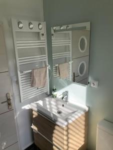 a bathroom with a sink and a mirror at Le sept in Ambleteuse +21 photos