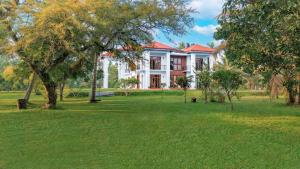 a large white house with a green yard at Welpalla Signature 