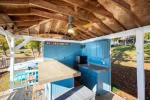 a kitchen with blue cabinets and a wooden ceiling at Dockside Dream – Your Perfect Waterfront Escape in Lexington