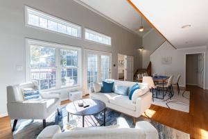 a living room with couches and chairs and a table at Dockside Dream – Your Perfect Waterfront Escape in Lexington
