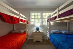 a bedroom with two bunk beds and a lamp at Dockside Dream – Your Perfect Waterfront Escape in Lexington +37 photos