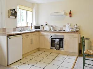 a kitchen with a sink and a stove at The Old Mill in Bampton