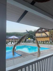a view from the balcony of a swimming pool at Guest house Dvir Pysanka in Kosiv