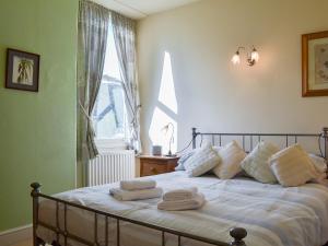 a bedroom with a bed with towels on it at Fell View in Ambleside +8 photos