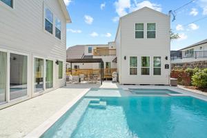 a swimming pool in front of a house at Downtown 7 min, 27 sleeps, Gated 2 homes, Accessible in Houston