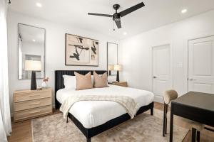 a bedroom with a bed with a ceiling fan at Downtown 7 min, 27 sleeps, Gated 2 homes, Accessible in Houston +76 photos
