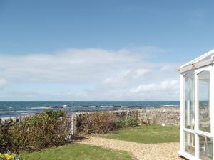 a view of the ocean from a house at Shore Cottage in Bellochantuy +4 photos