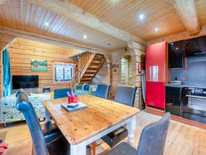 a dining room and kitchen with a wooden table and chairs at Ty Afal - Uk42099 in Carno +26 photos