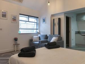 a living room with a bed and a couch at Whinacres Cottage 1894 in Conwy