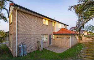 a house with two fire hydrants in front of it at Youth Castle in Brisbane