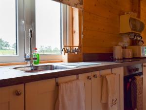 a kitchen with a sink and a window at Raynard's Retreat - Uk33401 in Hungerton