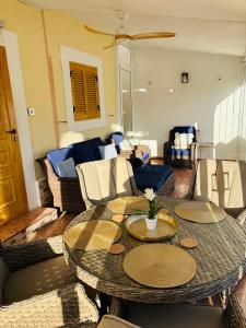 a living room with a table and chairs at Villa Limon Playa Flamenca in Alicante